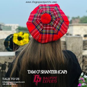 Close-up shot of a tartan tam, illustrating the hat's fine wool texture, secure elasticated band, and playful pompom, ideal for showcasing its traditional Scottish charm